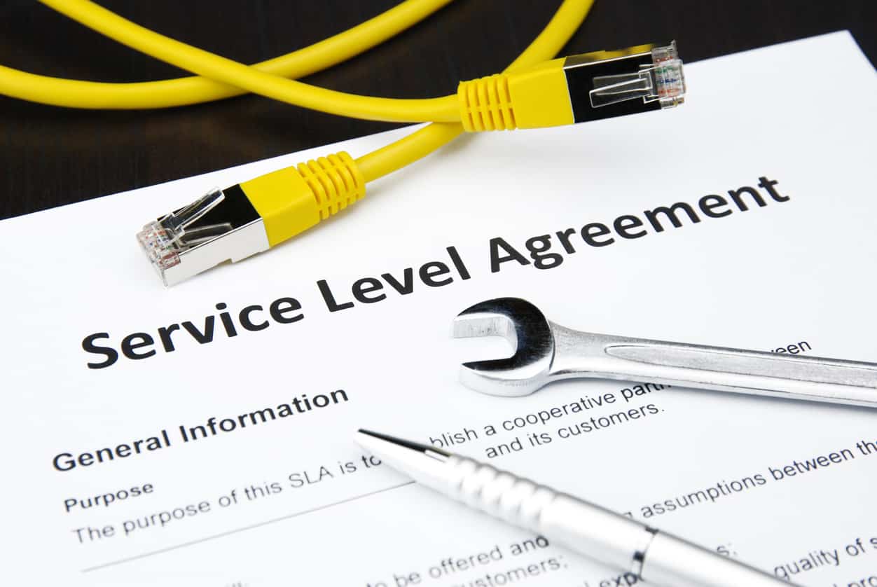 AWS Service Level Agreement with yellow cable, spanner and pen on top of it